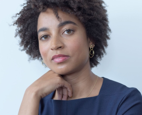 Headshot of Rujeko Hockley resting her chin on her folded hand.