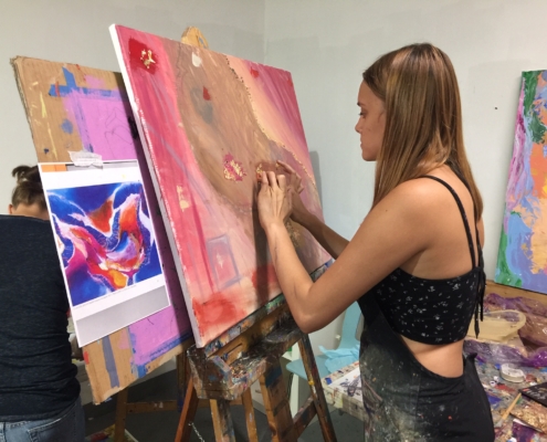 person painting on easel