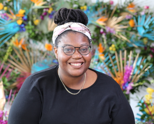 Woman smiling against a colorful background