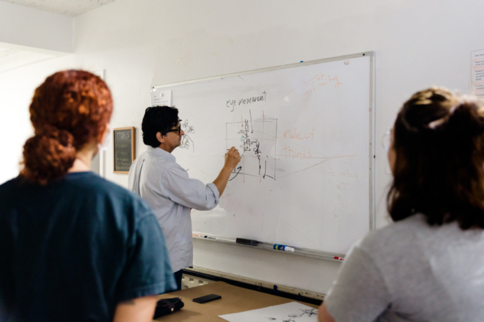 Raul Drawing Class Raul instructing on white board