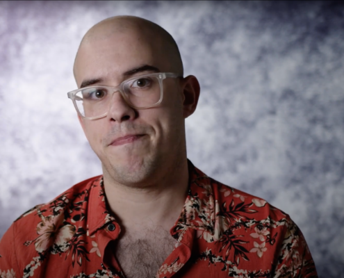 Christopher Lopez sitting against a gray background