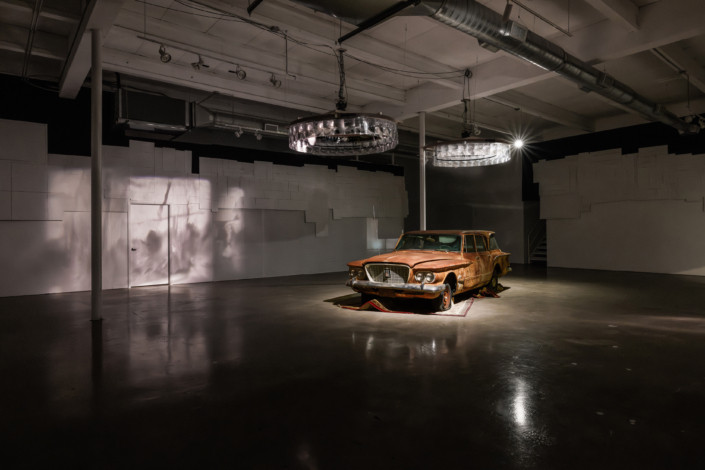 ThePatienceOfOrdinaryThings InstallationShot SoloProject Dads1960ValiantStationWagonDirtYearsOfCollectedNationalGeographicMagazinesRugTransparenciesLensesMovingLightsCardboardFabric KerryPhillips