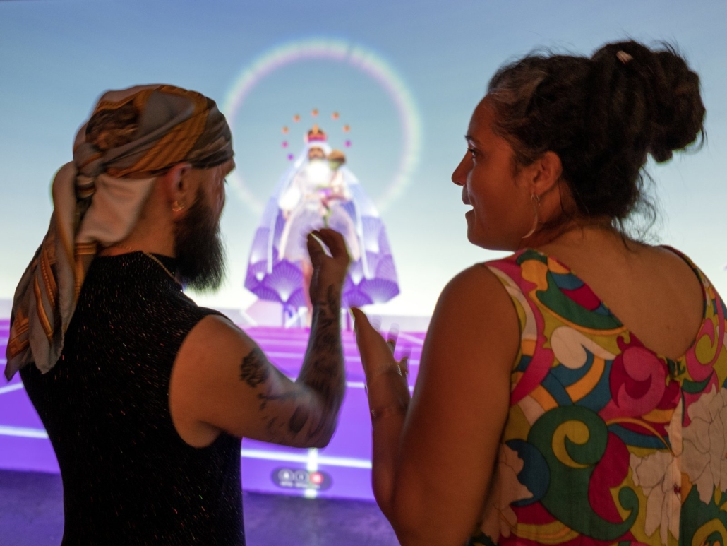 Two visitors in front of a large-scale virtual environment projection